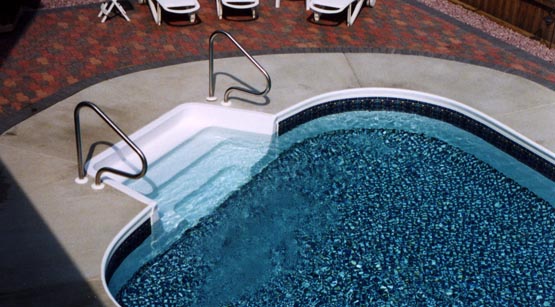 Finished inground pool filled with water